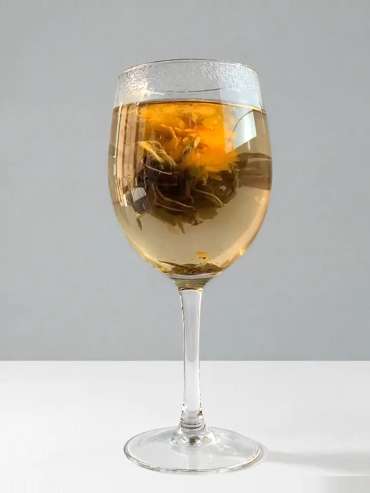The flower fully open in the glass